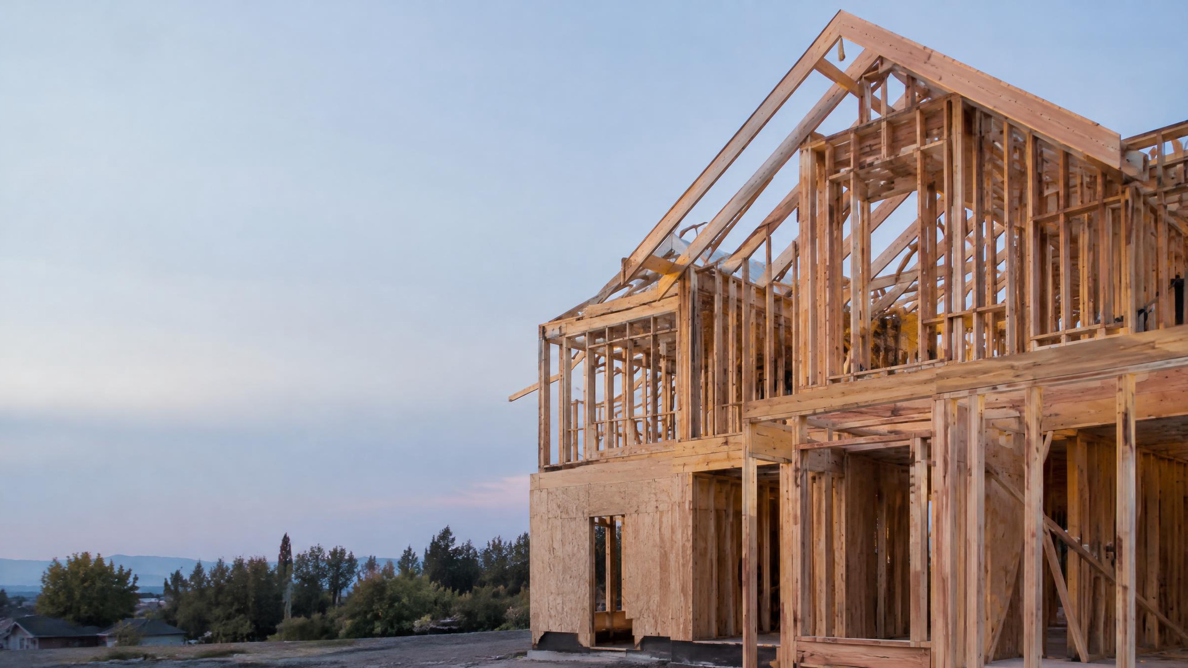 Timber structure under construction at dusk